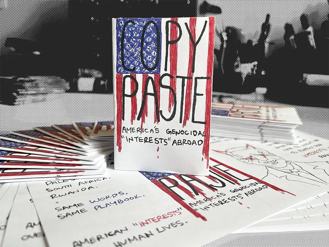 A folded zine sitting on a fanned out stack of other folded and unfolded zines.