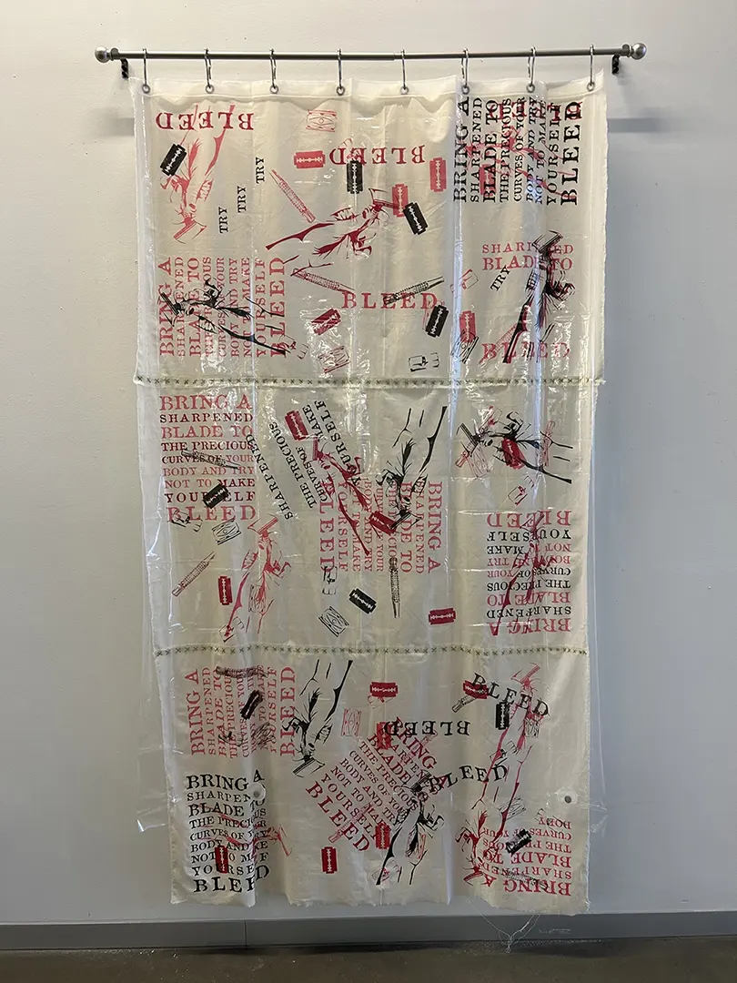 Shower curtain hanging from a curtain rod on a white wall. Printed on the inner 
                        muslin curtain in pink, red, and black are images of razor blades and text about body 
                        hair removal. There's a plastic curtain in front of the print.